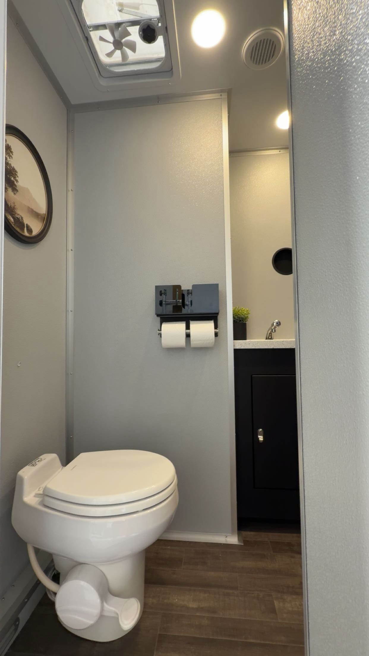 Clean private restroom suite with climate control and running water
