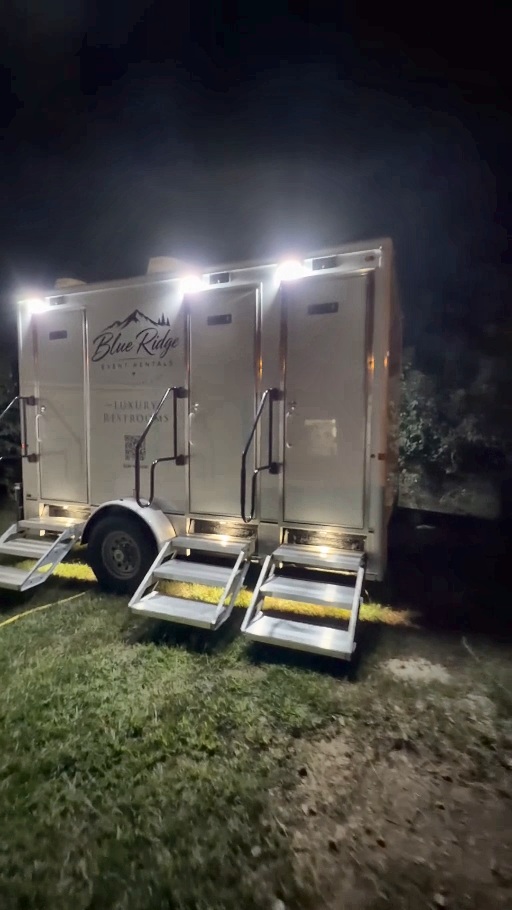 Blue Ridge luxury restroom trailer illuminated and ready for guests at night